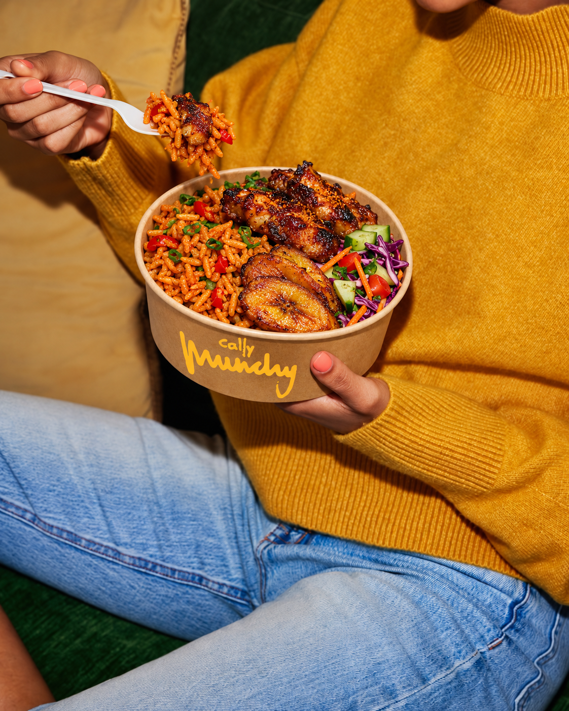 Guest holding a Cally Munchy bowl with jollof, chicken and plantain