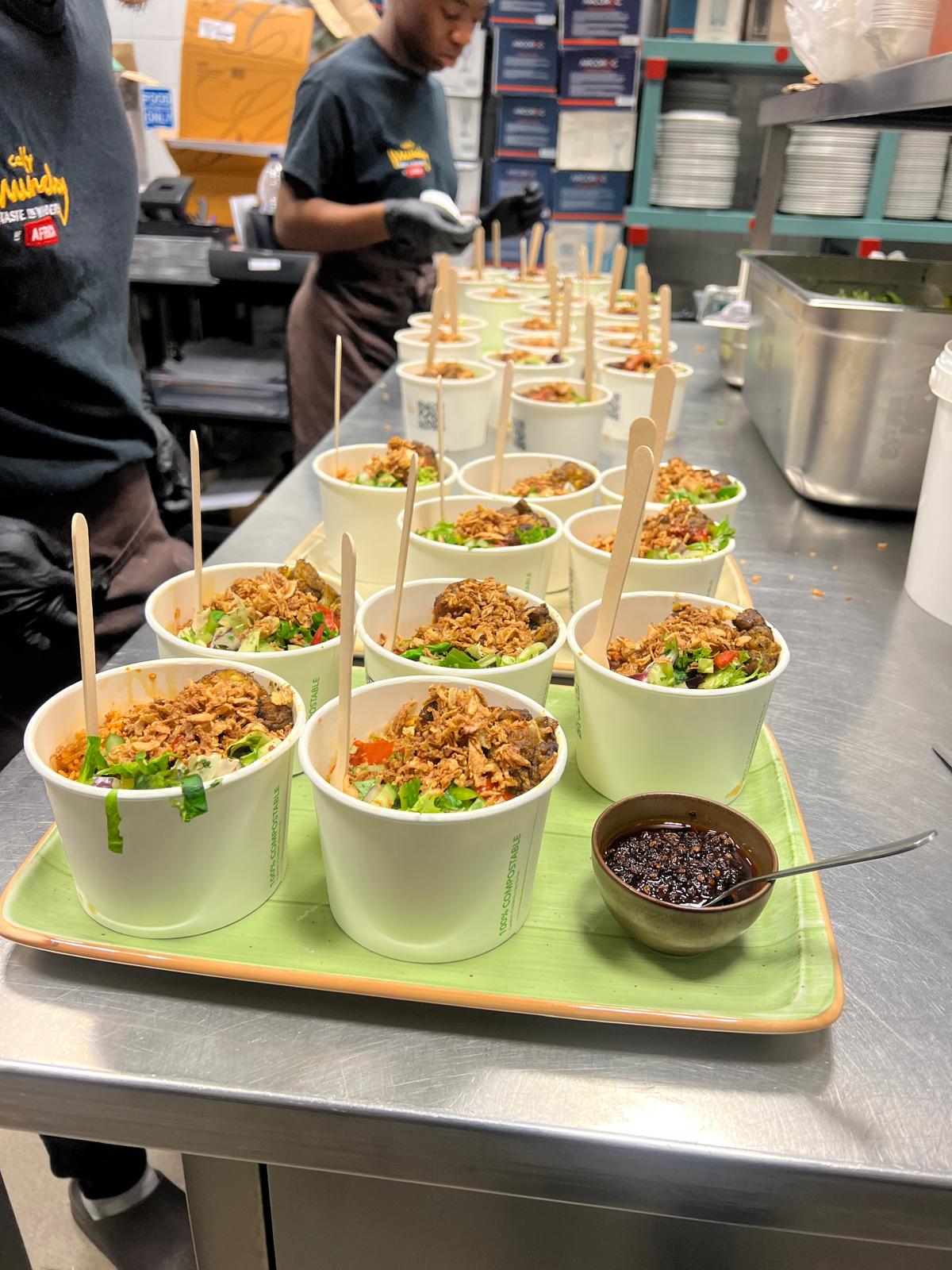 Team prepping rows of catering cups in the Cally Munchy kitchen